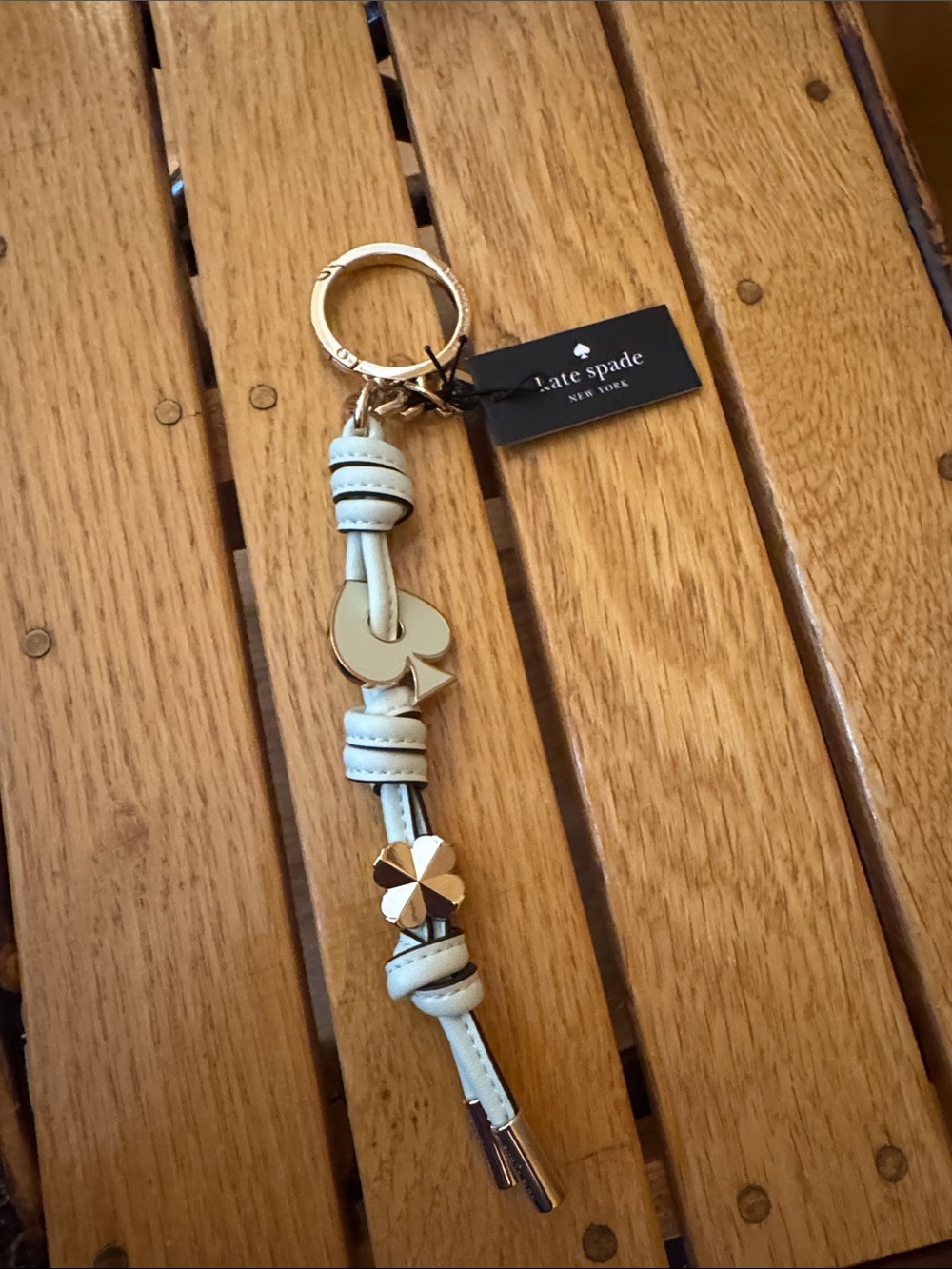 kate spade pale blue leather tassel keychain with gold charms